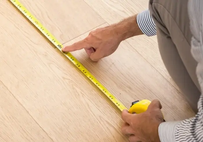 Man measuring floor | All American Remnants & Rolls